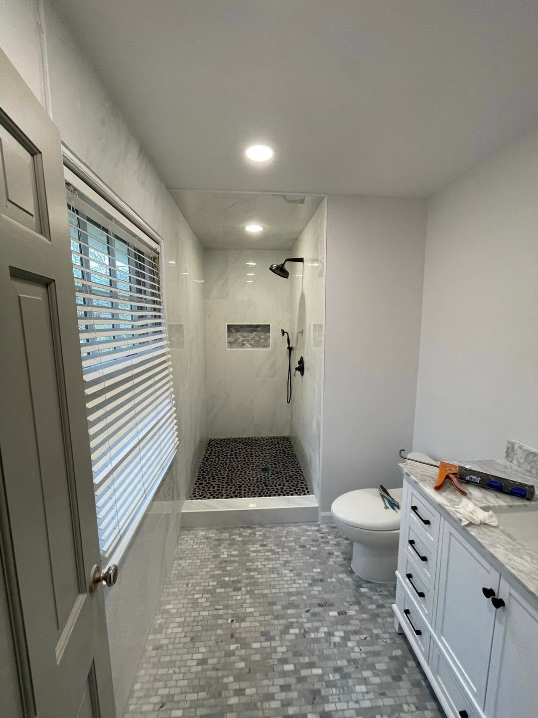 Finished bathroom remodel with walk-in shower and modern vanity